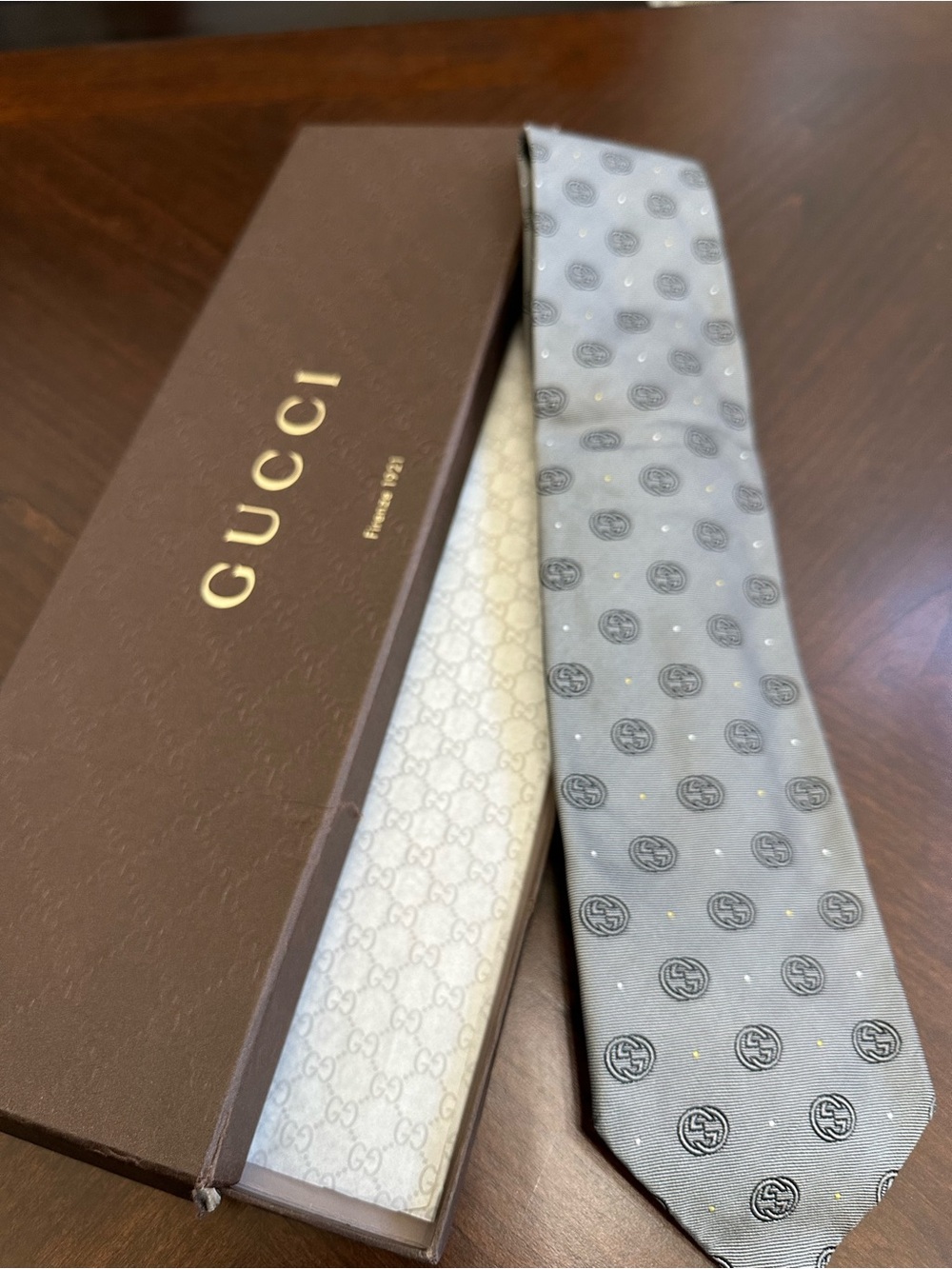 Gucci Light Gray Silk Tie with Black Logo Medallions and Gold Dots